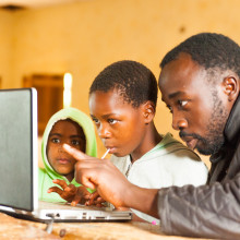 young african teacher involve school children in online learning