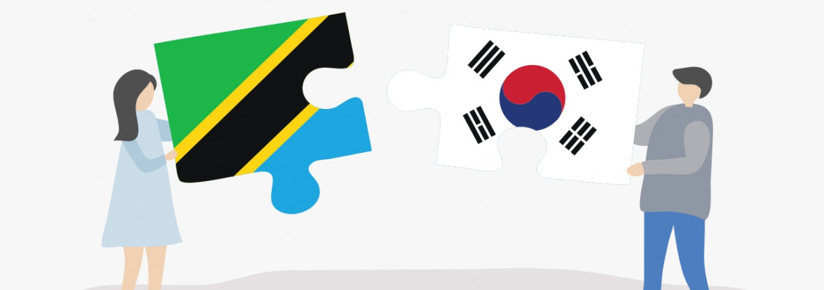 A lady holding the tanzanian flag, a man holding the korean flag